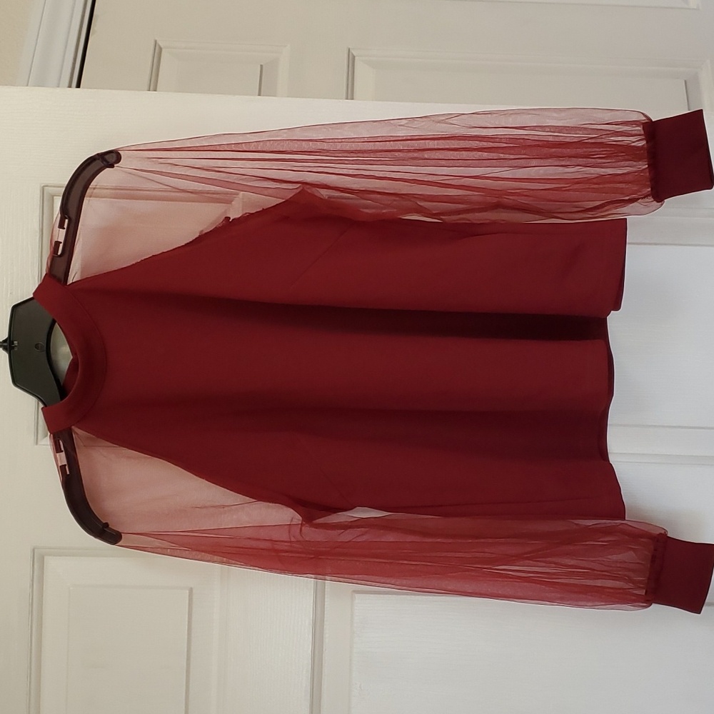 Blouse with sheer sleeves.
